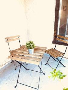 a wooden bench with a potted plant on a patio at Beautiful home near Disneyland. Entire place! in Orange