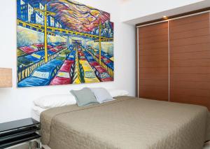 リオデジャネイロにあるLeblon Dream Apartmentのベッドルーム1室(ベッド1台付)が備わります。壁には絵画が飾られています。