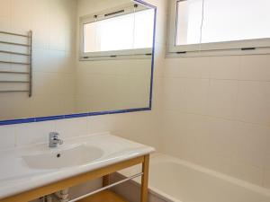 a bathroom with a sink and a mirror and a tub at Appartement Mèze, 4 pièces, 6 personnes - FR-1-604-5 in Mèze