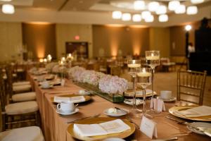 a long table with wine glasses and flowers on it at I Hotel and Illinois Conference Center - Champaign in Champaign
