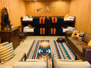 a living room with bunk beds and a couch at The Camp Blanco by Lodgewell - Riverfront retreat 2 Homes, Bunk House, Game Room & more in Blanco