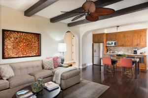 a living room with a couch and a ceiling fan at Terranea Resort in Rancho Palos Verdes