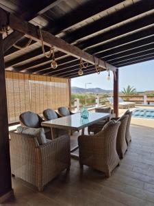 a dining room with a table and chairs at Casa Abuela Serapia in Tuineje +40 photos