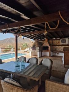 a dining room with a table and chairs and a pool at Casa Abuela Serapia in Tuineje
