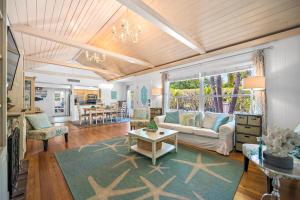a living room with a couch and a table at Beach Side Babe in Sarasota