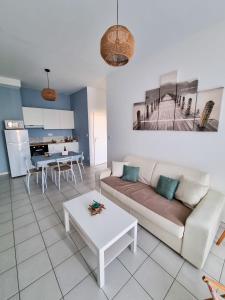 a living room with a couch and a table at A 200m de la plage - L'Océan - in Mimizan-Plage