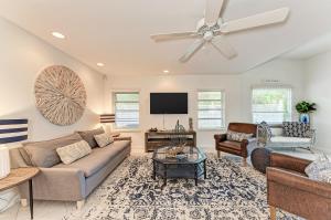 a living room with a couch and a tv at The Cottage on Lido Key in Sarasota