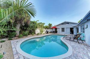 a swimming pool in the backyard of a house at The Cottage on Lido Key in Sarasota