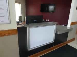 a reception desk with a white sign in a room at Red Roof Inn Greencastle South - Cloverdale in Cloverdale