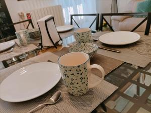 a table with plates and cups and spoons on it at Vien mequé in Città di Castello +14 photos