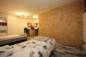 a bedroom with two beds and a desk in it at Family Residence Center Sarajevo in Sarajevo