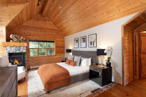 a bedroom with a bed and a fireplace at Pinnacle Ridge 34 - Ski In Ski Out, Private Hot Tub, Recently Renovated, Gas Fireplace in Whistler