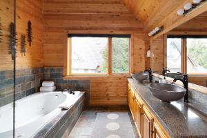 a bathroom with two sinks and a tub at Pinnacle Ridge 34 - Ski In Ski Out, Private Hot Tub, Recently Renovated, Gas Fireplace in Whistler +41 photos