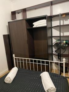 a bedroom with a bed with two pillows on it at (023) Lovely 2 bedroom house London in London