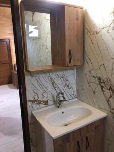 a bathroom with a sink and a mirror at Anka Bungalov Hotel in Kemer
