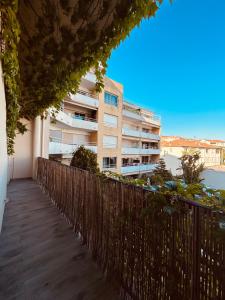 un balcon avec une clôture et un bâtiment dans l'établissement Charmant T2 proche du centre ville, à Cannes