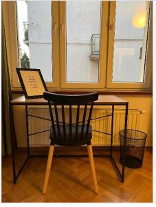 a chair sitting in front of a desk with a laptop at Cheerful 3 bedroom city house in Krakow