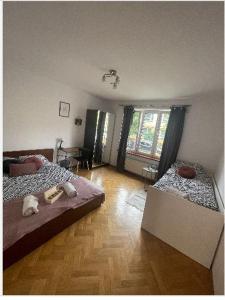 a bedroom with two beds and a wooden floor at Cheerful 3 bedroom city house in Krakow