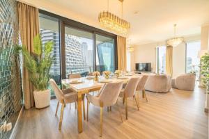 a dining room with a table and chairs at FIRST CLASS 3BR with full BURJ KHALIFA and FOUNTAIN VIEW in Dubai