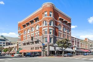 a large red brick building on a city street at The Keating Hotel in San Diego