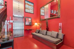 a red living room with a couch against a red wall at The Keating Hotel in San Diego