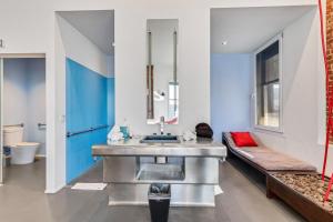 a bathroom with a sink and a bench at The Keating Hotel in San Diego