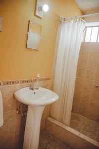 W łazience znajduje się umywalka i prysznic. w obiekcie Hotel Shinula w mieście Huehuetenango