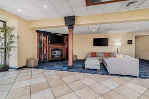 a living room with a couch and a fireplace at Best Western Plus Augusta Civic Center Inn in Augusta