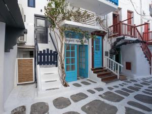 a blue door on a white building with stairs at Silvernoses Little Venice, Mykonos Town in Mikonos