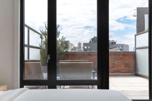 a bedroom with a view of a balcony at Arlo SoHo in New York