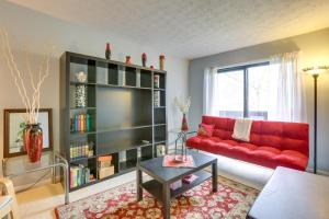 a living room with a red couch and a book shelf at Frankfort Home with 3 Balconies - 3 Mi to Downtown in Frankfort