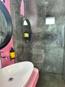 a bathroom with a sink and a glass shower at Casa Rosa Hotel & Spa in San Cristóbal de Las Casas