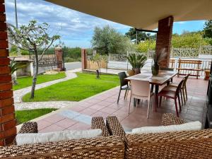 a patio with a table and chairs on a patio at Villa Settimia a 50 mt dalla spiaggia! in Àrbatax