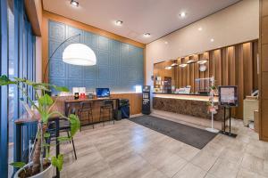 a lobby of an office with a desk and a counter at Vella Suite Hotel in Suwon