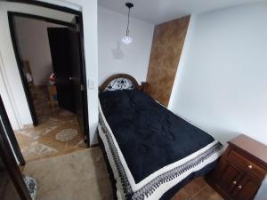 Cama pequeña en habitación con colchón negro en Los balcones ll en Medellín