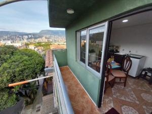 a balcony with a table and a view of a city at Los balcones ll in Medellín