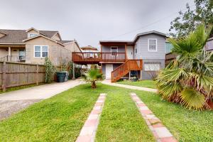 a house with a deck and a yard at Peaceful Hideaway - Upstairs Unit B in Galveston