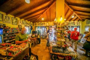 a group of people standing in a store with a store at Troia Pension in Akçapınar