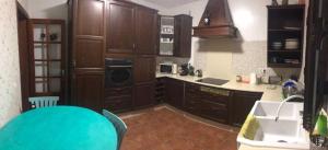 a kitchen with wooden cabinets and a sink and a counter at LANZATE! in Tinajo