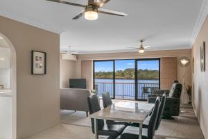 a dining room with a table and a view of a lake at Unit 7 18 Endeavour Parade in Tweed Heads