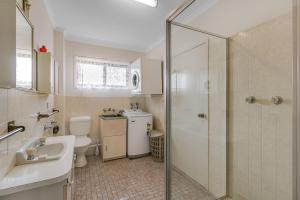 a bathroom with a shower and a sink and a toilet at Unit 7 18 Endeavour Parade in Tweed Heads