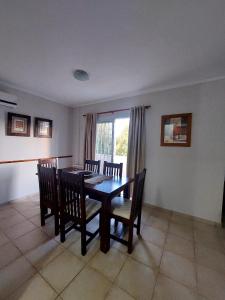 a dining room with a table and chairs and a window at Depto Centro de Carlos Paz in Villa Carlos Paz