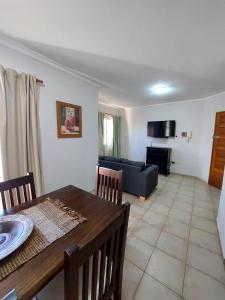 a living room with a table and a couch at Depto Centro de Carlos Paz in Villa Carlos Paz +15 photos