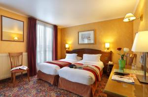 a hotel room with two beds and a desk at Hotel Paix Republique in Paris +37 photos
