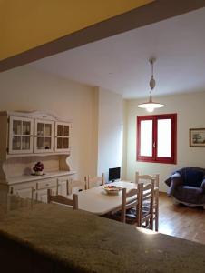 a kitchen and living room with a table and chairs at Gran Sasso in Prati di Tivo