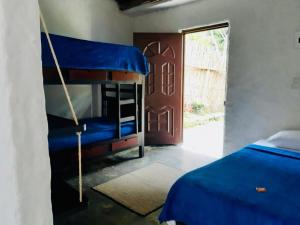 a bedroom with two bunk beds in a room with a door at Casa completa Bosque Ibagué in Ibagué