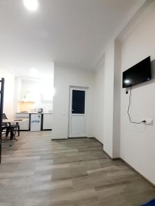a white room with a flat screen tv on a wall at Dream House Ureki in Ureki