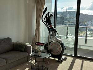 a vacuum in a living room next to a window at 1BR City Apt-Parking&View& Homey in Canberra