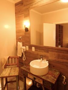 a bathroom with a sink and a mirror at Pousada Betânia in Gramado