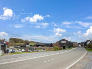 een lege weg in een stad met een blauwe lucht bij Cozy holiday home in Gedinne in the heart of the Ardennes in Gedinne